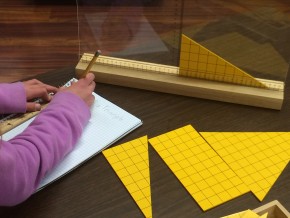 student measuring yellow triangles