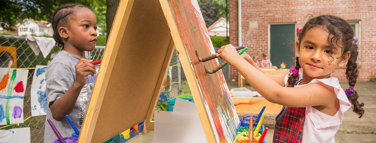 two children painting outside